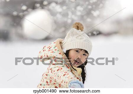 Kid playing in the snow View Large Photo Image Stock Image - Kid playing in the snow. Fotosearch
