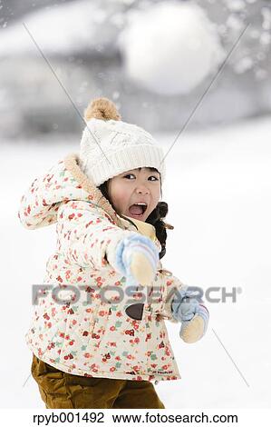 Kid playing in the snow View Large Photo Image Stock Image - Kid playing in the snow. Fotosearch