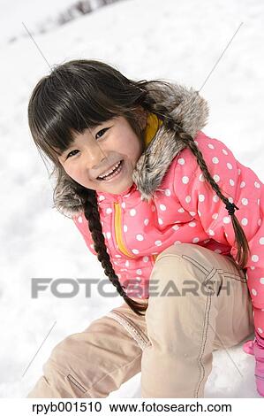 Kid playing in the snow View Large Photo Image Stock Image - Kid playing in the snow. Fotosearch