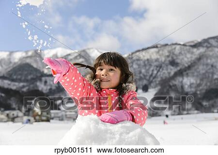 Kid playing in the snow View Large Photo Image Stock Image - Kid playing in the snow. Fotosearch