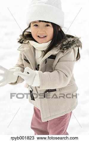 Kid playing in the snow View Large Photo Image Stock Image - Kid playing in the snow. Fotosearch