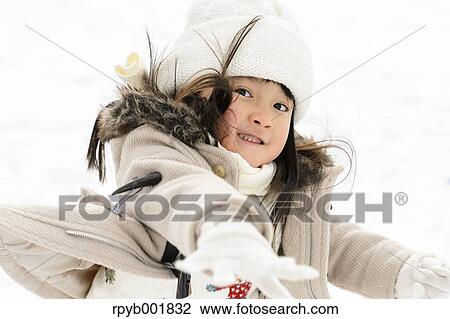 Kid playing in the snow View Large Photo Image Stock Image - Kid playing in the snow. Fotosearch