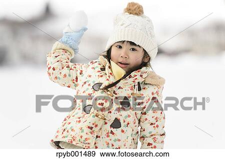 Kid playing in the snow View Large Photo Image Stock Photo - Kid playing in the snow. Fotosearch