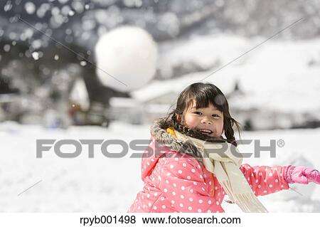 Kid playing in the snow View Large Photo Image Stock Photo - Kid playing in the snow. Fotosearch