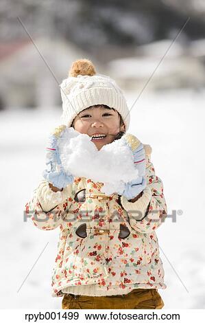Stock Photo - Kid playing in the snow. Fotosearch