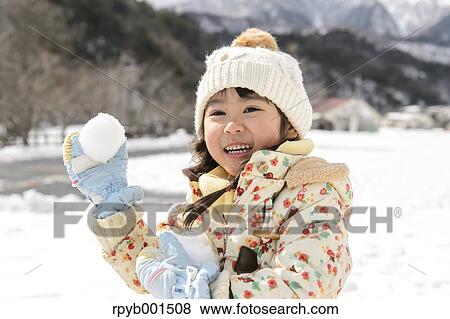 Kid playing in the snow View Large Photo Image Stock Photo - Kid playing in the snow. Fotosearch