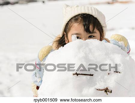 Kid playing in the snow View Large Photo Image Stock Photo - Kid playing in the snow. Fotosearch