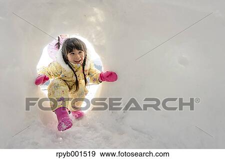 Kid playing in the snow View Large Photo Image Stock Photo - Kid playing in the snow. Fotosearch