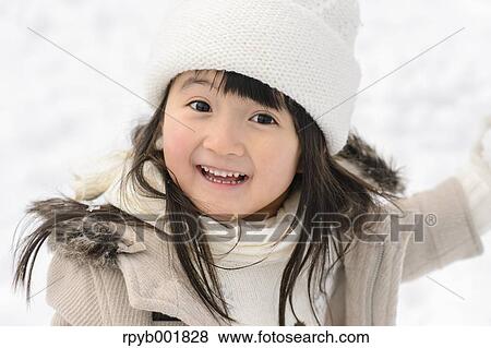 Kid playing in the snow View Large Photo Image Stock Photo - Kid playing in the snow. Fotosearch