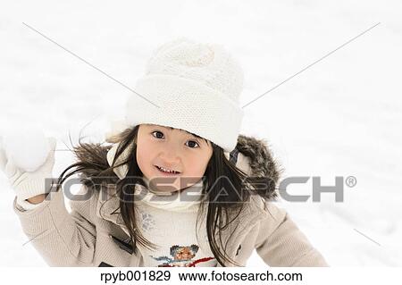 Kid playing in the snow View Large Photo Image Stock Photo - Kid playing in the snow. Fotosearch