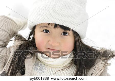 Kid playing in the snow View Large Photo Image Stock Photo - Kid playing in the snow. Fotosearch