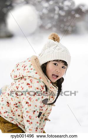 Kid playing in the snow View Large Photo Image Stock Photograph - Kid playing in the snow. Fotosearch