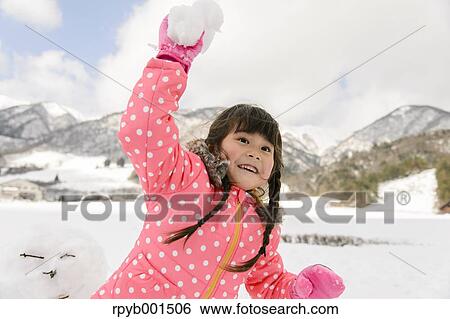 Kid playing in the snow View Large Photo Image Stock Photograph - Kid playing in the snow. Fotosearch