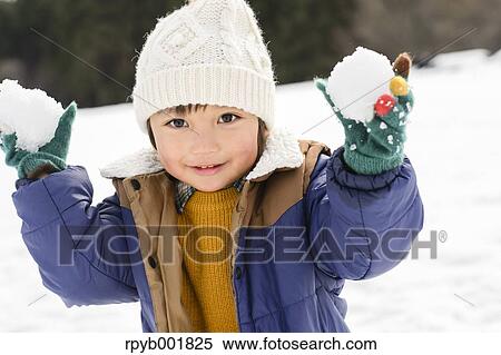 Kid playing in the snow View Large Photo Image Stock Photography - Kid playing in the snow. Fotosearch