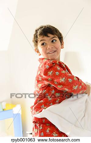 Kid playing on bed in a pijama View Large Photo Image Stock Image - Kid playing on bed in a pijama. Fotosearch
