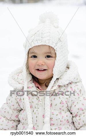 Stock Image - Kid playing on snow. Fotosearch