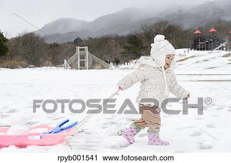 Kid playing on snow View Large Photo Image Stock Image - Kid playing on snow. Fotosearch