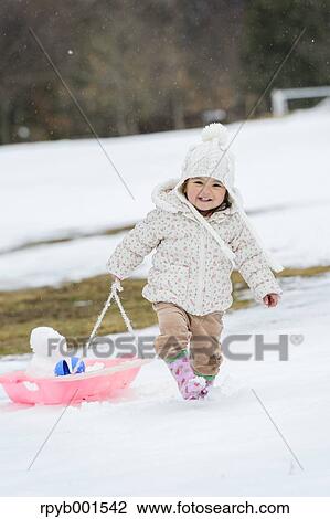 Kid playing on snow View Large Photo Image Stock Image - Kid playing on snow. Fotosearch