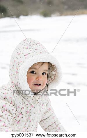 Stock Photo - Kid playing on snow. Fotosearch