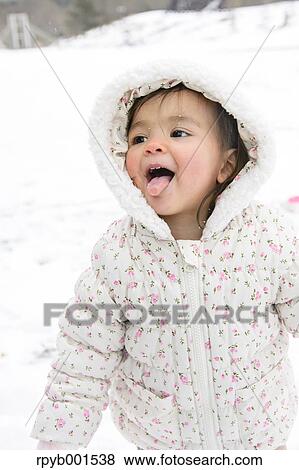 Stock Photo - Kid playing on snow. Fotosearch