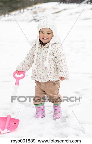 Stock Photo - Kid playing on snow. Fotosearch