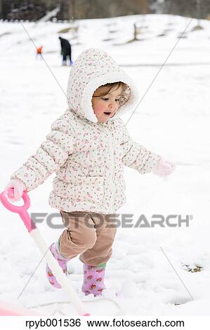 Kid playing on snow View Large Photo Image Stock Photograph - Kid playing on snow. Fotosearch
