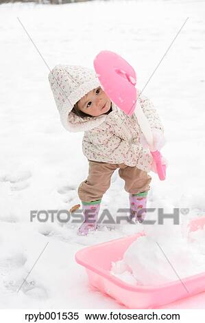 Stock Photography - Kid playing on snow. Fotosearch