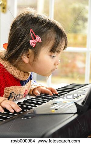Kid playing piano View Large Photo Image Picture - Kid playing piano. Fotosearch