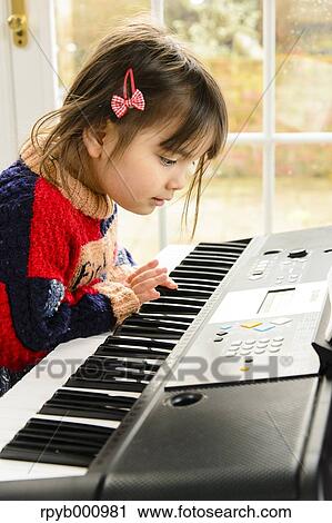 Kid playing piano View Large Photo Image Stock Image - Kid playing piano. Fotosearch