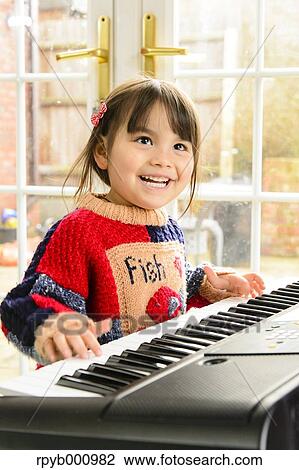 Kid playing piano View Large Photo Image Stock Image - Kid playing piano. Fotosearch