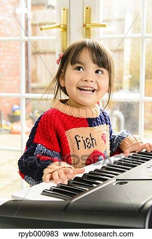 Kid playing piano View Large Photo Image Stock Image - Kid playing piano. Fotosearch