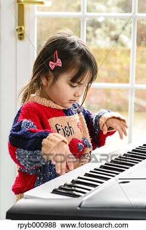 Kid playing piano View Large Photo Image Stock Photo - Kid playing piano. Fotosearch