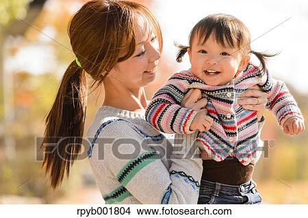 Picture - Kid playing with her mother at the park. Fotosearch