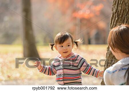 Kid playing with her mother at the park View Large Photo Image Stock Image - Kid playing with her mother at the park. Fotosearch