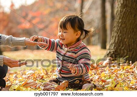 Kid playing with her mother at the park View Large Photo Image Stock Photo - Kid playing with her mother at the park. Fotosearch