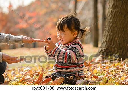 Kid playing with her mother at the park View Large Photo Image Stock Photo - Kid playing with her mother at the park. Fotosearch