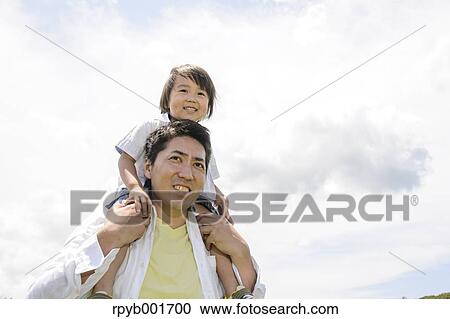 Stock Image - Kid with dad at the park. Fotosearch