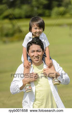 Kid with dad at the park View Large Photo Image Stock Photo - Kid with dad at the park. Fotosearch