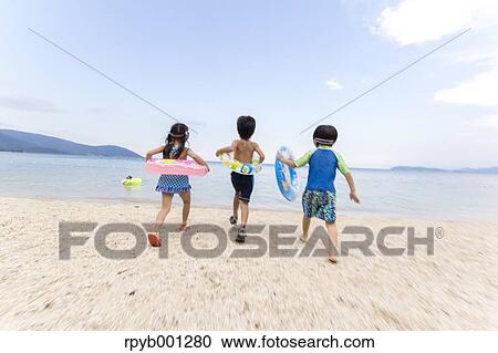 Stock Image - Kids at the beach. Fotosearch