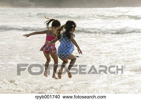 Stock Image - Kids at the beach. Fotosearch