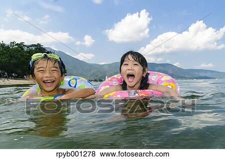 Kids at the beach View Large Photo Image Stock Photo - Kids at the beach. Fotosearch