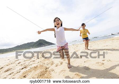 Kids at the beach View Large Photo Image Stock Photo - Kids at the beach. Fotosearch