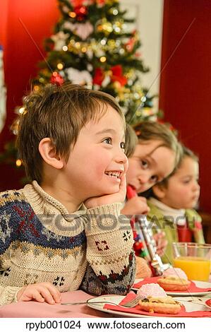 Kids eating in the house at Christmas View Large Photo Image Picture - Kids eating in the house at Christmas. Fotosearch