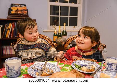 Kids eating in the house at Christmas View Large Photo Image Picture - Kids eating in the house at Christmas. Fotosearch