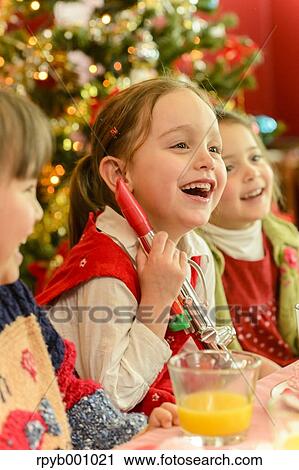 Kids eating in the house at Christmas View Large Photo Image Stock Image - Kids eating in the house at Christmas. Fotosearch