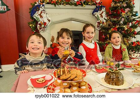 Kids eating in the house at Christmas View Large Photo Image Stock Image - Kids eating in the house at Christmas. Fotosearch