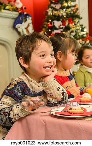 Kids eating in the house at Christmas View Large Photo Image Stock Image - Kids eating in the house at Christmas. Fotosearch