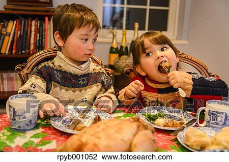 Kids eating in the house at Christmas View Large Photo Image Stock Image - Kids eating in the house at Christmas. Fotosearch