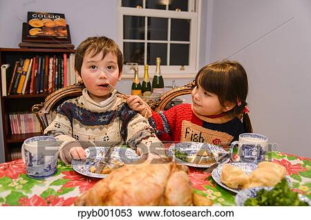 Kids eating in the house at Christmas View Large Photo Image Stock Image - Kids eating in the house at Christmas. Fotosearch