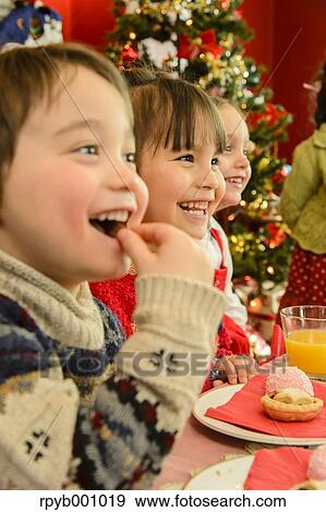 Kids eating in the house at Christmas View Large Photo Image Stock Photo - Kids eating in the house at Christmas. Fotosearch